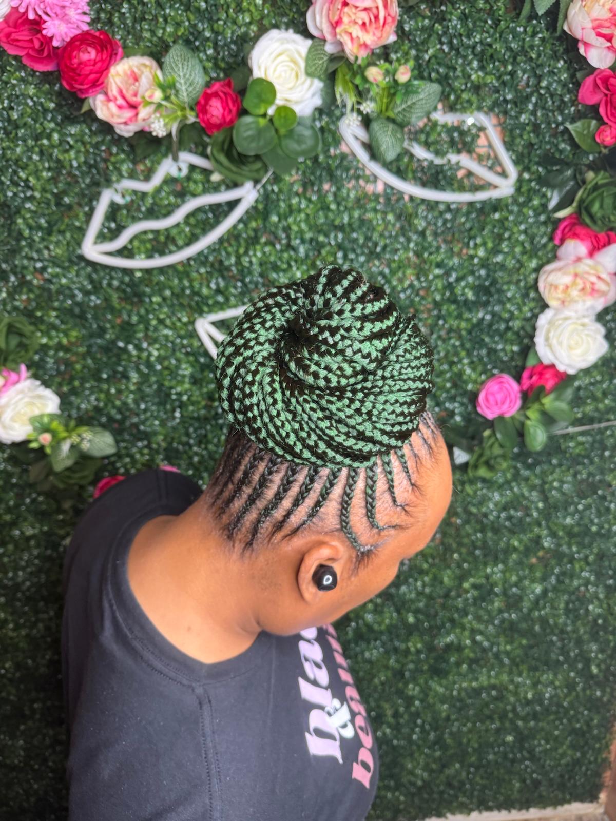 Cornrow updo with green braided bun by Joyce Braids